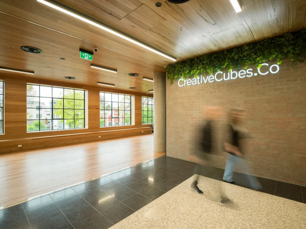 Creative Cubes co work space in Carlton interior photography office people walking in bright daylight area.